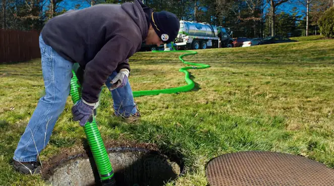 Service technician performing residential septic pumping and drainage maintenance in Boise, ID